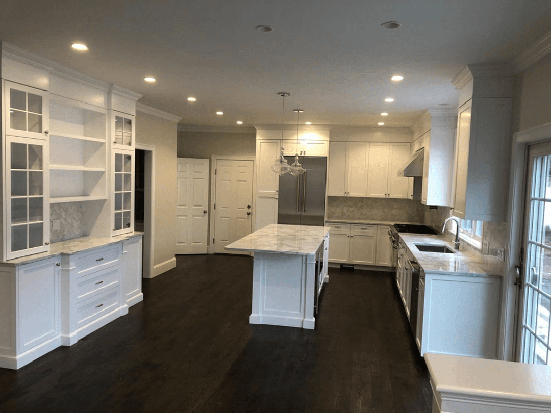 White custom kitchen remodel with marble island by Begnami Home Improvements